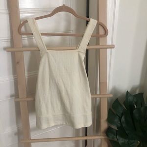 Cream colored tank with cross straps